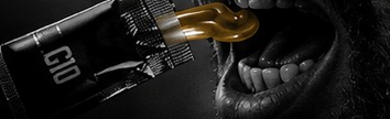 Energy gel being squeezed into an athlete’s open mouth.